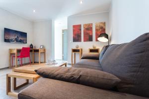 a living room with a couch and a table at Villa Velvet in Villeneuve-Loubet