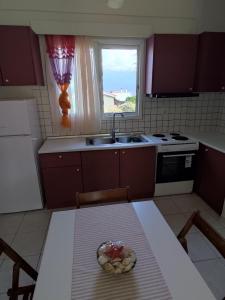 a kitchen with a table with a bowl of fruit on it at ARETI4 in Petalidi