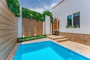 a swimming pool in the backyard of a house at BUNGALOW private pool bbq air conditioning stunning ocean view in Adeje