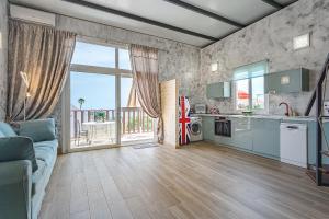 a living room with a couch and a kitchen at BUNGALOW private pool bbq air conditioning stunning ocean view in Adeje