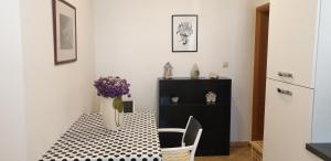 a dining room table with a vase of flowers on it at Pende in Banjol
