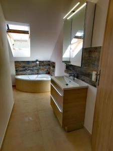 a bathroom with a tub and a sink and a bath tub at Apartament Luna in Zamość
