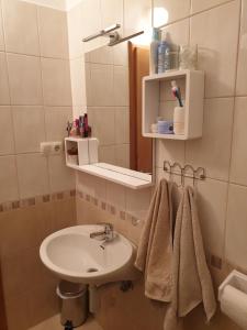 a bathroom with a sink and a mirror and towels at Pende in Banjol +8 photos