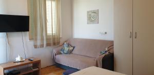 a living room with a couch and a table at Pende in Banjol