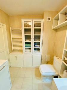 a bathroom with a toilet and a window at La maison de macarons, your sweet home in Cluj in Cluj-Napoca