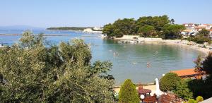 a beach with people swimming in the water at Pende in Banjol
