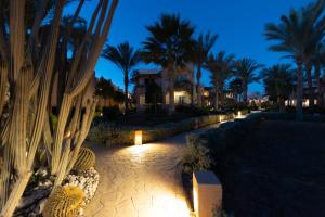 a night view of a resort with palm trees and lights at BLUE Lagoon View Resort & Spa in Marsa Alam City