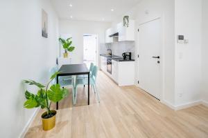 a kitchen and dining room with a table and chairs at Charming Central Cityflats in Antwerp