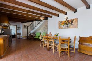 a kitchen and dining room with a table and chairs at YourHouse Es Molinet Villa in El Port de la Selva