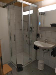 a bathroom with a shower and a sink at Studio Schija in Sankt Antönien
