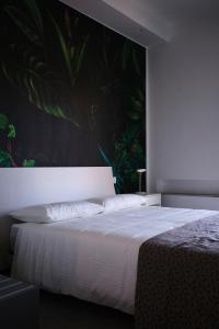 a bedroom with a large bed with a large painting on the wall at Casa Dante in Galatina