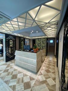 a lobby with a reception desk in a building at Hotel President - Vintage Hotel in centro in Riccione