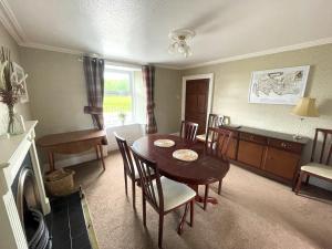 a kitchen and dining room with a table and chairs at Pass the Keys Spacious 3BR Cottage in Beautiful Rural Setting in Castle Douglas