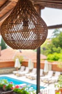 a wicker basket hanging over a table with chairs at VILLA SOL in Sunny Beach