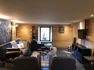 a living room with a couch and a dog in it at Ferme des deux Frères, Autrans, Vercors in Autrans