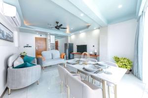 a dining room and living room with a table and chairs at Marukab Plaza in Male City +29 photos