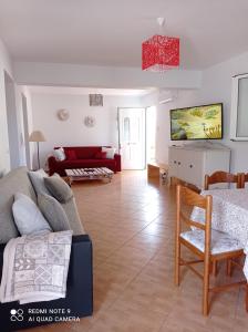 a living room with a couch and a table at Marina's House in Khelmáta