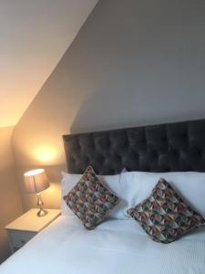 a bedroom with a bed with two pillows on it at Bellinter House in Navan