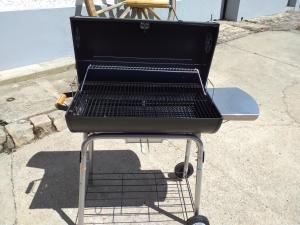 a grill sitting on a stand on a sidewalk at Gîte du Plouy in Caumont