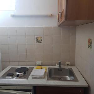a kitchen counter with a sink and a stove at Vila Horizont in Sveti Stefan +125 photos