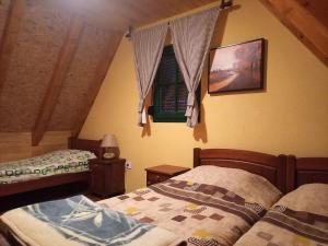 a bedroom with two beds and a window at Vila Darija in Žabljak