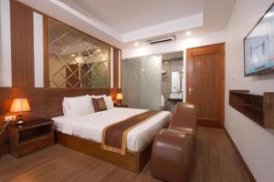 a hotel room with a bed and a television at B & B Hotel Quan Hoa in Hanoi