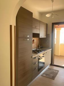 a kitchen with a large stainless steel refrigerator at Smeralda in Olbia