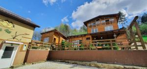 a wooden building with a fence in front of it at Apartment Little Paradise in Visoko