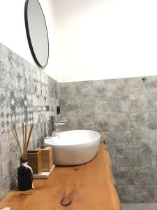 a bathroom with a white tub on a wooden floor at Appartamento vicino Rho Fiera in Cornaredo