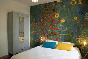 a bedroom with a floral wall with a bed at Villa Matignon in Bagnoles de l'Orne