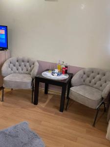 two chairs and a coffee table in a living room at ALEM Hotel in Yerevan