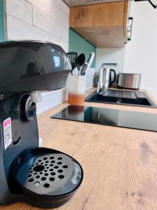 a mixer sitting on a counter in a kitchen at LE QUAI 6 - Studio neuf CALME LUMINEUX - CLIM - WiFi - Gare à 200m in Agen