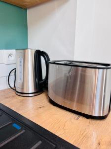 a silver pot sitting on top of a kitchen counter at LE QUAI 6 - Studio neuf CALME LUMINEUX - CLIM - WiFi - Gare à 200m in Agen