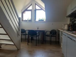 a kitchen with a table and chairs in a room at Villa Horizon in Rowy