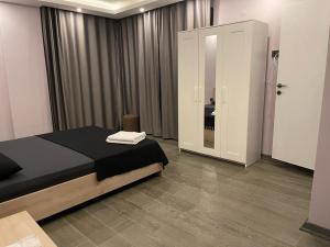 a bedroom with a bed and a door with a mirror at Özel havuz ve deniz manzaralı yeni villa in Kusadası +15 photos