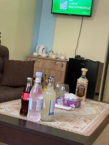a table with bottles of milk and alcohol on it at ALEM Hotel in Yerevan