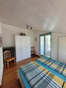 a bedroom with a large bed and a window at Ferienwohnung Bally in Brunnen