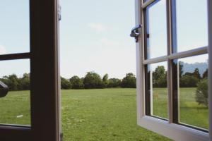 an open window with a view of a field at The Bell Broadway in Broadway