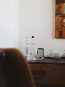 a counter with two glass bottles on top of it at The Bell Broadway in Broadway