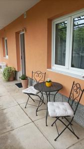 a patio with a table and chairs in front of a house at Wilma in Čavle