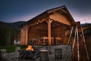 a log cabin with a fire pit in front of it at MM LUCKY apartments in Belá