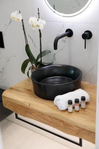 a black sink on a wooden table in a bathroom at Naxos White Concept in Naxos Chora +16 photos