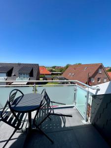 a chair sitting on the roof of a balcony at Hotel Ocean in Norddeich