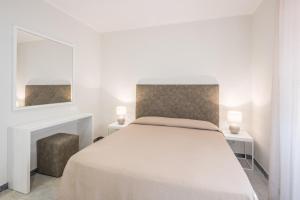 Postel nebo postele na pokoji v ubytování Hotel Cavalieri Del Mare