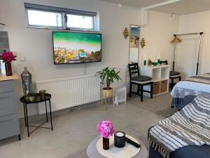 a living room with a tv on the wall at Vik Österlen in Simrishamn