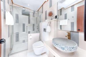 a bathroom with a sink and a toilet at Marukab Plaza in Male City