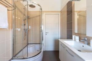 a bathroom with a shower and a sink at Apartments Otia Seaview in Porat +33 photos