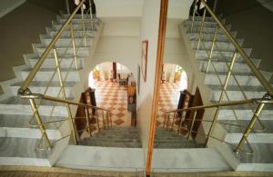 a spiral staircase with metal railings in a building at Hotel Arberia in Tirana