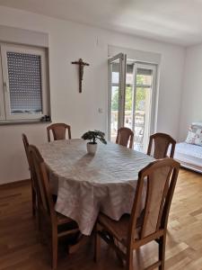 uma mesa de jantar com um vaso de plantas em Apartman Marijana em Ljubuski