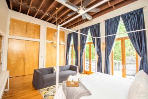 a bedroom with a bed and a couch at Largest Rooftop w Firepit - Vaulted LUXE Penthouse in Knoxville